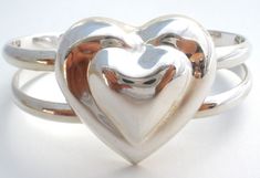 Mexican Jewelry - This is a sterling silver double shank cuff bracelet with a heart centerpiece. It is hallmarked JHR Taxco Mexico 925, the heart is almost 1.5" wide, bracelet in front is almost .75", weight is 40.6 grams, inside circumference is 6" and opening is 1". The bracelet is high polished and shows a lot of reflections in the pictures. Mexican Jewelry, Wide Bracelet, Bracelet Vintage, Sterling Silver Heart, Silver Heart, A Heart, Vintage Silver, Cuff Bracelet, Cuff