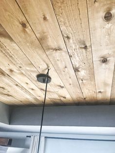 the ceiling is made from wood planks and has two lights on each side of it