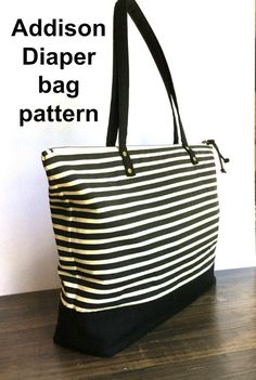 a black and white striped bag sitting on top of a wooden table