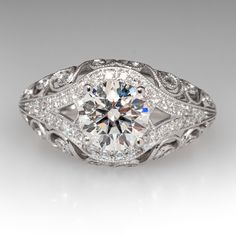 an antique style diamond engagement ring with filigrees