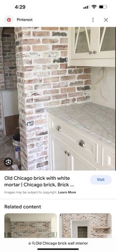 an old brick wall is being remodeled with white paint and new cabinets in the kitchen