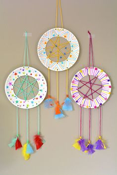 paper plate dream catchers hanging on the wall with text overlay that says how to make a dream catcher