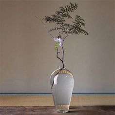 a vase with flowers in it sitting on a table