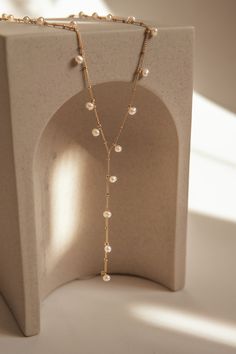 The Aries Pearl Necklace is an versatile piece handcrafted using gold-filled beaded chain and mini freshwater pearls. The design is reminiscent of art nouveau and will add a touch of creativity to your outfit. Adjustable 5cm additional chain in the back to adjust length with a hanging pearl. Packaged in an elegant plastic-free reusable jewelry box, they make the perfect gift or special treat for oneself.  14k gold-filled components Freshwater pearls Hypoallergenic, suitable for even the most sensitive skin Delivered in a 100% silk jewelry pochette inside a gift box Sustainable magnetic closure jewelry box and customizable card   Please note, as we use only natural pearls, shape and size may vary slightly.  We offer a one year guarantee from the date of delivery and unlimited repairs. Elegant Rose Gold Beaded Chain Necklace, Elegant Gold Pearl Lariat Necklace, Minimalist Gold Lariat Necklace With Pearls, Minimalist Gold Pearl Lariat Necklace, Gold Pearl Lariat Chain Necklace, Gold Pearl Chain Backdrop Necklace, Gold Pearl Drop Backdrop Necklace, Gold Backdrop Necklace With Pearl Drop, Elegant Gold Backdrop Necklace With Pearl Charm