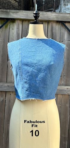 Upcycled vintage denim crop top made from recycled materials handmade in Canada. Raw hemm, neckline and shoulder. Metal hook and eye closure on the back. Stretch Denim Cropped Crop Top, Cropped Cotton Denim Blue Vest, Cropped Denim Blue Cotton Vest, Fitted Cotton Cutoff Top, Stretch Denim Blue Cropped Crop Top, Stretch Cropped Top In Denim Blue, Stretch Cropped Denim Blue Top, Cropped Medium Wash Denim Vest, Denim Blue Crop Top