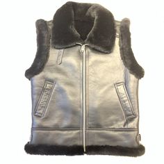 skin: shearling style: vest color: black Black Sheepskin Outerwear With Padded Collar, Sleeveless Sheepskin Vest For Fall, Fall Sheepskin Sleeveless Vest, Sleeveless Black Outerwear With Fleece Lining, Black Sleeveless Biker Outerwear, Fitted Black Sheepskin Fur Coat, Black Sleeveless Vest With Padded Collar, Black Sheepskin Fur Coat With Faux Fur Lining, Classic Black Sheepskin Outerwear