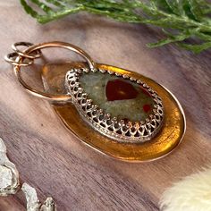 Puddingstone from Michigan, handcrafted into a cabochon and placed in a custom copper bezel setting. Pendant measures approximately 1.0 x 1.5 inches. Gold Copper Teardrop Pendant Jewelry, Spiritual Bronze Oval Jewelry, Spiritual Oval Bronze Jewelry, Rust Teardrop Handmade Jewelry, Artisan Bronze Gemstone Jewelry, Brass Cabochon Jewelry For Jewelry Making, Gold Oval Copper Necklace, Artisan Bronze Teardrop Jewelry, Artisan Carnelian Gold Jewelry