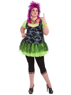 a woman with pink hair wearing a green and black dress is posing for the camera