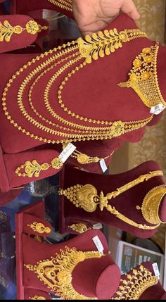 several red and gold items on display in a store