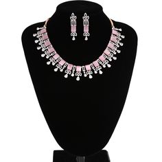 American Diamond bridal collar choker necklace studded with rose pink quartz and clear CZ stones encrusted on rose gold background. Necklace comes with a pair of matching earrings. This is very unique and beautiful Indian Necklace set studded high quality AD stones beautifully decorated work. Stone shape: emerald cut and Pear Necklace Length: 9 inches+ Length of Extender is 9 inches Earring Length: 1.75 inches Contents: 1 Necklace, 2 Earrings Best suitable for Party Wear / Fashion Wear for Any O Elegant Pink Rhinestone Jewelry Set, Pink Crystal Jewelry With Sparkling Stones, Pink Crystal Jewelry Sets For Formal Occasions, Formal Pink Crystal Jewelry Sets, Pink Crystal Jewelry Sets With Rhinestones, Elegant Pink Crystal Jewelry Sets, Pink Rhinestone Jewelry Set For Party, Pink Jewelry Sets With Sparkling Stones For Wedding, Pink Crystal Jewelry With Diamond Accents