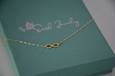 "Want to make a statement without saying word? This lovely 14K gold infinity charm necklace is a lovely expression of affection and a symbol of friendship and love. Available in two different chain types, a delightful treat for anyone! The necklace will be shipped in a beautiful gift box. ★ Infinity charm is 14K yellow gold 14mm x 5mm (17/32\" X 7/32\"). ★ Necklace is 14K yellow gold . Please choose 1.5mm flat cable chain (delicate ) or 1.3mm Double rope chain. Please read our policies before yo Infinity Cable Chain Jewelry Gift, Simple Cable Chain Jewelry As Gift, Simple Cable Chain Jewelry Gift, Elegant Yellow Gold Charm Necklace For Bridesmaid Gift, Dainty Yellow Gold Infinity Necklace, Delicate Gold Infinity Jewelry, Dainty Gold Infinity Necklace, Dainty Yellow Gold Infinity Jewelry, Dainty Infinity Jewelry With Delicate Chain