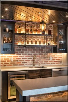 a kitchen with brick walls and an island in front of the stove top oven is lit by recessed lights