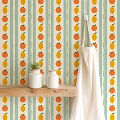 an orange and white wallpaper with potted plants on a shelf next to it