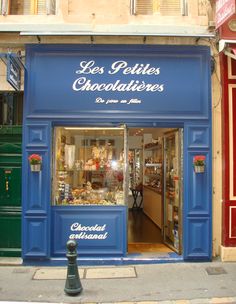 a store front with the door open on a city street