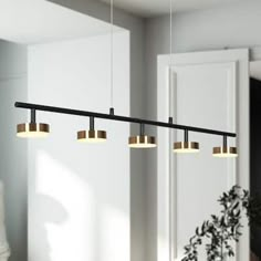 three lights hanging over a table in a room