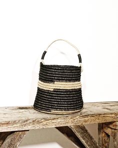 Round small and elegant bag made of very unique African palm leave and linen cord Bottom 22cm wide Bag itself 20cm height Black Woven Beach Bag Made Of Natural Fiber, Handwoven Black Bucket Bag For Vacation, Black Handwoven Bucket Bag For Vacation, Black Straw Bucket Beach Bag, Black Bucket Bag With Leather Handles For Market, Black Handwoven Beach Bag For Vacation, Black Crochet Straw Bag With Leather Handles, Black Handwoven Natural Fiber Beach Bag, Black Woven Straw Beach Bag