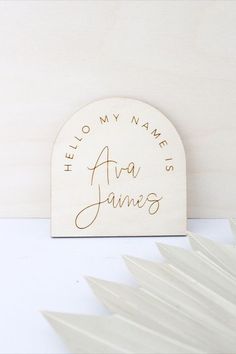 a wooden plaque with the words hello my name's ava james written on it