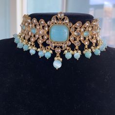 This gorgeous Light blue choker set is made from fine polki stones. Comes as a set with earrings and a head piece. ALL SALES ARE FINAL ON JEWELRY. KINDLY MESSAGE ME FOR ANY INQUIRIES. Traditional Blue Festive Choker, Blue Kundan Jeweled Jewelry, Blue Jewelry For Diwali Party, Traditional Turquoise Choker Jewelry, Blue Jewelry For Party And Diwali, Bollywood Style Kundan Jeweled Choker, Blue Choker Jewelry For Festive Occasions, Blue Festive Jewelry Choker, Blue Jeweled Jewelry For Festivals