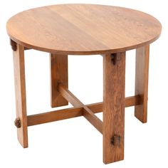 a round wooden table sitting on top of a white background