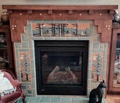 a fireplace in a living room with a cat sitting on the floor