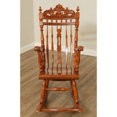 a wooden rocking chair sitting on top of a hard wood floor