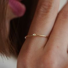 Tiny, minimalistic 14-karat solid gold ring, featuring a 0.02-carat diamond. Perfect for a refined, understated look. Material: 14-karat solid gold Diamond: 0.02 carat Gold Colors: Available in yellow, rose, or white gold Band Width: Ultra-slim 0.7 mm Packaging: Comes with a beautiful gift box Ideal for wearing alone or layering with other rings, this dainty minimalist ring enhances any outfit with its subtle sparkle and sleek design. Minimal Diamond Ring, Solid Gold Rings, White Gold Band, Minimalist Rings, Beautiful Gift Boxes, Gold Diamond, Gold Color, Solid Gold, Diamond Ring