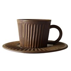 a brown coffee cup sitting on top of a saucer