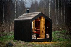 a small cabin in the middle of a forest