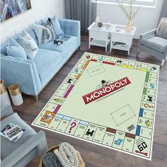 a monopoly board game is on the floor in a living room with blue couches