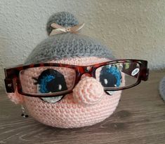 a crocheted stuffed animal with glasses on it's head and eyeglasses