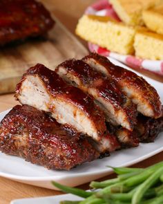 ribs covered in bbq sauce on a white plate