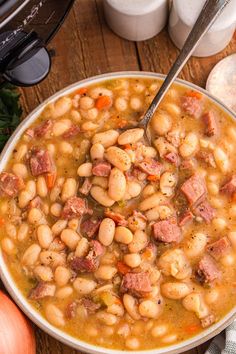 a white bowl filled with beans and ham