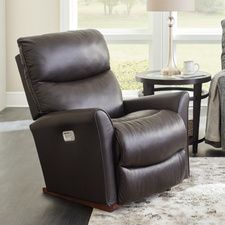 a living room with two recliners and a table in front of the window