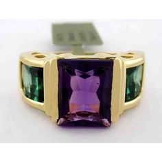 Karat: 10k Gold Gemstones: 1 Genuine Amethyst - 2.54 Carats Amethyst Grades, Hue... Purple Tone... Medium Saturation... Vivid Cut...Excellent No Inclusions Or Flaws 2 Genuine Tsavorite Total Ct Weight: 2.82 Carats Tsavorite Grades, Hue... Green Tone... Medium Dark Saturation... Vivid Cut... Excellent Net Weight: 6.5 Grams Shape: Emerald Cut Ring Size: 7 (Resizing Service Available If Needed) Resizing Service Available To Any Finger Size For A Low Cost Of $25.00 (Request This Service If Needed) A Formal Green Amethyst Ring With Accent Stones, Formal Green Amethyst Ring With Gemstone Accents, Green Amethyst Ring For Formal Occasions, Green Amethyst Ring In 14k Gold, Green Amethyst Ring Fine Jewelry, Formal Green Amethyst Jewelry, Tsavorite Ring, Emerald Cut Ring, Purple Tone