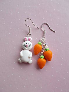 two carrots and a bunny are hanging from earrings