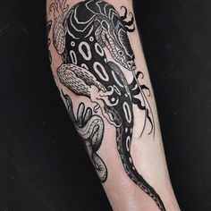 a black and white tattoo on the leg of a person with an octopus in it