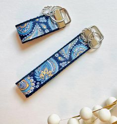 Preppy, sturdy, and functional keychain wristlets.  Perfect for your work keyfob, housekeys, or car keys.   The bright wristlet makes it easy to find in your purse and fits nicely on most wrists! Measures 5 inches in length. Made with a pretty soft cotton webbing and high quality, printed grosgrain ribbon.  Accented with our signature knotted ring. Handmade Blue Keychain As Gift, Handmade Blue Keychain For Gift, Blue Keychain With Key Clip As Gift, Blue Keychain With Key Clip For Gift, Blue Keychain With Key Leash For Everyday Use, Blue Keychains With Key Leash For Everyday Use, Blue Rectangular Keychain For Gifts, Rectangular Blue Keychain For Gifts, Keychain Wristlets