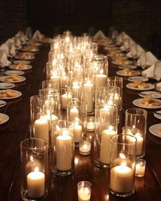 a long table with many lit candles on it