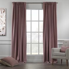 a living room filled with furniture and a large window covered in pink drapes