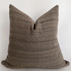 a brown and black pillow on a white background