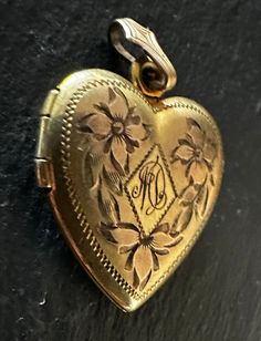 "Charming Sweetheart vintage locket, puffy heart, hand engraved beautifully floral design, sentimental, romantic-monogramed front and back-dated 6-15-42 Aunt Connie and Uncle Sam.  The condition is good for its age, closes tight, has decorative bale, any slight wear commensurate with age-photos show the details.  Size not counting bale is approx. 7/8\" by 3/4\".  A cherished treasure from the past." Antique Gold Engraved Locket Necklace For Anniversary, Vintage Heart Pendant Locket Necklace For Wedding, Antique Heart Charm Locket Necklace For Anniversary, Heirloom Heart Locket Necklace For Wedding, Heirloom Engraved Locket Necklace For Anniversary, Antique Heart Pendant Locket Necklace For Anniversary, Heirloom Style Engraved Locket Necklace, Heirloom Style Engraved Locket Necklace For Vintage Collection, Classic Engraved Heart Locket Necklace