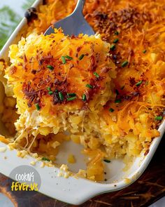 a casserole dish filled with macaroni and cheese topped with green onions