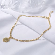 Make a sophisticated personal style statement and add a dash of luster to any ensemble with this sublime anklet. Beautifully crafted in sterling silver, it will help you represent your initial with elegant flair. Give personalized jewelry gift - represent your initials in style with this small tag on a beautifully crafted figaro chain.Weight: 4.548 gWidth: 9.9 mmHeight: 13.4 mmThickness: 1.8 mmMaterial: 925 SilverStone Type: Jeulia® StonePlating Color: Yellow GoldLength: 270 mm Adjustable Gold Sterling Silver Anklets, Personalized Silver Anklets, Elegant Sterling Silver Anklets With Adjustable Chain, Gold Sterling Silver Anklet As Gift, Personalized Adjustable Elegant Anklet, Elegant Adjustable Chain Anklet As Gift, Elegant Personalized Adjustable Anklet, Personalized Gold Elegant Anklets, Elegant Personalized Gold Anklets