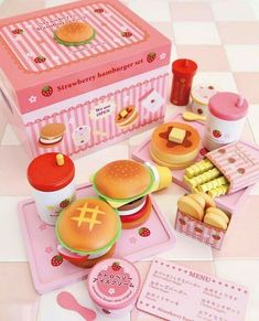 an assortment of toys including hamburgers and macaroni and cheese