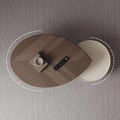 an overhead view of a table with a cup and remote control on it in the middle