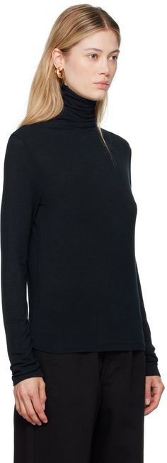 Semi-sheer stretch viscose- and wool-blend jersey turtleneck. Raw edge at collar. Supplier color: Navy Elegant Turtleneck Mock Neck Top, Elegant Mock Neck Top For Layering, Fine Knit Turtleneck For Workwear, Stretch Fine Knit Turtleneck For Work, Sheer Turtleneck, Jersey Turtleneck, Raw Edge, Wool Blend, Turtle Neck