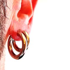 a close up of a persons ear with two rings attached to the back of it