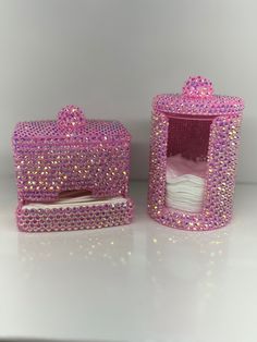 two pink boxes with white sheets in them on a counter top, one has a tissue dispenser and the other is made out of swaro beads