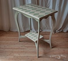 a small table with a checkerboard design on the top and shelf below it