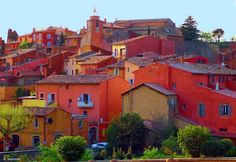 the city is full of colorful buildings and trees